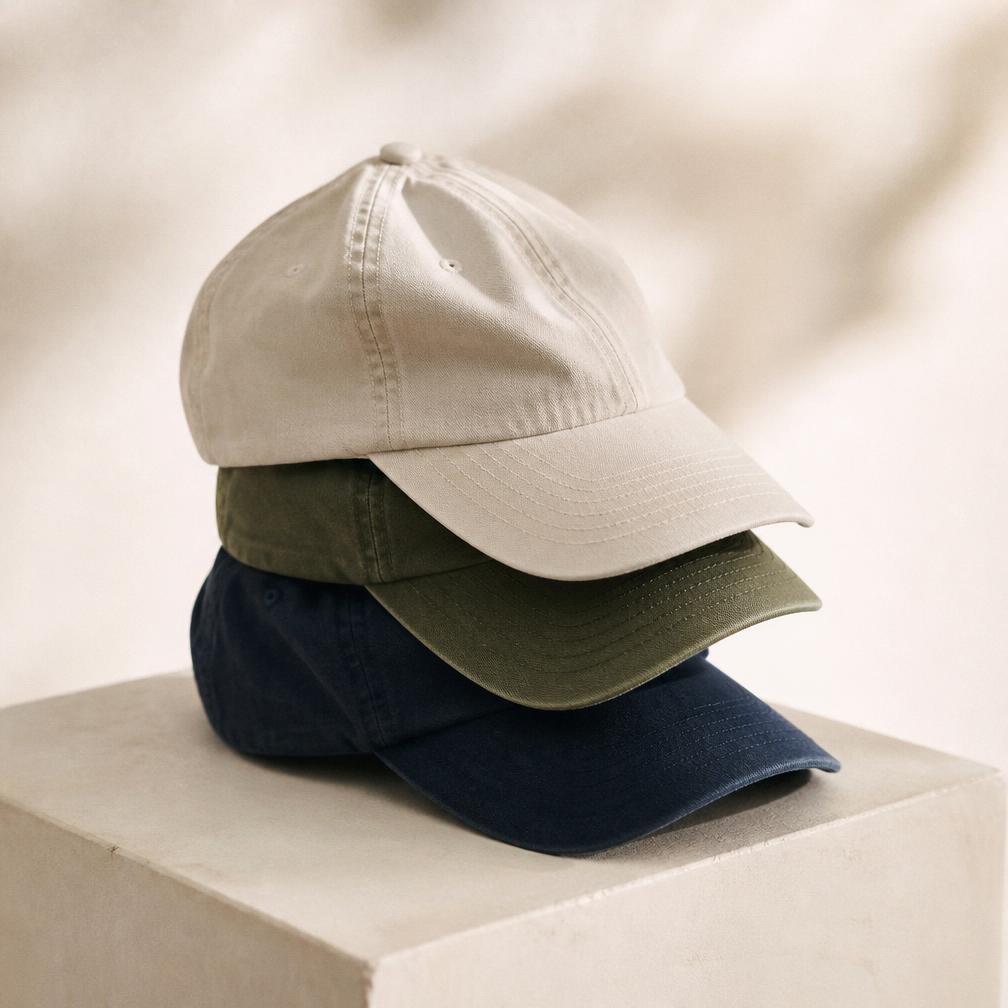 Three washed cotton CHILLI caps stacked in cream, olive and navy